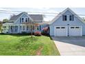 Charming blue two-story home with an attached two-car garage and well-manicured lawn at 3241 Long Shoals Rd, Lincolnton, NC 28092