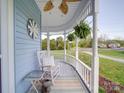 Inviting front porch with rocking chair, potted plants, and a view of the surrounding neighborhood at 3241 Long Shoals Rd, Lincolnton, NC 28092