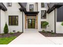 Stunning front entrance with a black metal door and wooden beam accents at 3268 Sherman Dr, Lancaster, SC 29720