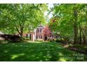Beautiful brick home with mature trees, lush lawn and landscaping at 3622 Roxburgh Ln, Gastonia, NC 28056