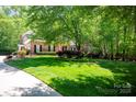 Well-maintained lawn and landscaping surround this charming brick home at 3622 Roxburgh Ln, Gastonia, NC 28056