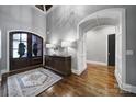 Spacious foyer with dark wood doors, hardwood floors and neutral color scheme creates an inviting entrance at 4071 Poplar Ridge Dr, Fort Mill, SC 29715