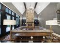 Grand living room features stone fireplace, vaulted ceilings, chandelier, and ample seating with an oversized couch at 4071 Poplar Ridge Dr, Fort Mill, SC 29715