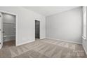 A bright bedroom features neutral carpet, fresh paint, and an adjacent bathroom with tub at 4378 Reed Creek Dr, Sherrills Ford, NC 28673
