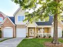 Charming two-story home with a brick and siding exterior, a well-manicured lawn, and attached two-car garage at 4407 Coventry Row Ct, Charlotte, NC 28270