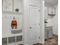 Bright entryway with a built-in bench, coat hooks, and access to a laundry room at 5009 Cherry Gum Ct, Matthews, NC 28105