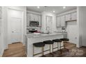 Modern kitchen featuring granite countertops, stainless steel appliances, and a convenient breakfast bar at 5017 Cherry Gum Ct, Matthews, NC 28105