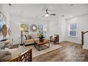 Inviting living room with modern decor, hardwood floors, bright light, and a staircase at 5017 Cherry Gum Ct, Matthews, NC 28105
