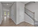 The entryway features hardwood floors and a staircase leading to the upper level at 5345 Cherrie Kate Ct # 1804, Stanley, NC 28164