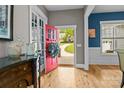 Inviting foyer with a red door, wood floors, and elegant decor, offering a warm welcome into the home at 6743 Fox Ridge Cir, Davidson, NC 28036