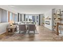 Bright living room featuring a cozy fireplace, modern decor and large windows for natural light at 7108 Brookview Ln, Sherrills Ford, NC 28673