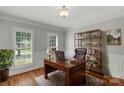 Cozy office space with hardwood floors, a wooden desk, and bright natural light at 9008 Skipaway Dr, Waxhaw, NC 28173
