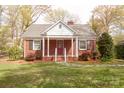 Beautiful brick house with a classic design, featuring a covered porch and well-manicured lawn at 920 N Sixth St, Albemarle, NC 28001