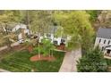 An aerial view of a two-story home with mature trees, green lawn, and convenient driveway at 9319 Harps Mill Ct, Charlotte, NC 28270