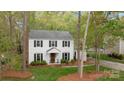 Traditional two-story home with manicured landscaping and a detached carport at 9319 Harps Mill Ct, Charlotte, NC 28270