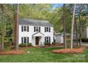 Traditional two-story home with manicured landscaping and a detached carport at 9319 Harps Mill Ct, Charlotte, NC 28270