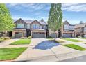 Eye-level street view of newly constructed townhomes with manicured lawns and tree-lined driveways at 9551 Glenburn Ln, Charlotte, NC 28278