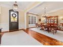 An elegant dining room featuring hardwood floors, large windows, and traditional furnishings at 1012 Shippon Ln, Waxhaw, NC 28173