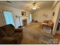 Living room with a decorative fireplace, neutral carpet, and lots of space at 112 Juanita Dr, Pineville, NC 28134