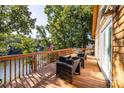 Large wooden deck with wicker seating and beautiful lake views at 119 Harbor Ln, Mount Gilead, NC 27306