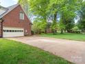 Spacious garage with driveway providing ample parking, complementing the brick exterior at 126 Pointer Se Ct, Concord, NC 28025