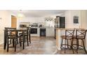 Functional kitchen space featuring white cabinets, appliances, and eat-in dining area at 140 Misty Ln, Rockwell, NC 28138