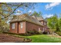 Picture of the brick house showing the expansive lawn and back of the property with a well maintained landscape at 1427 Doe Ridge Ln, Fort Mill, SC 29715