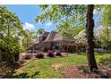 Lovely backyard with a manicured lawn, a fenced perimeter, a stone patio, and a pergola at 1427 Doe Ridge Ln, Fort Mill, SC 29715