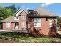Beautiful shot of a red brick house with white trimmed windows and a well-kept yard at 1427 Doe Ridge Ln, Fort Mill, SC 29715
