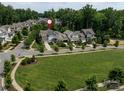 Neighborhood aerial view showcasing well-manicured lawns, mature trees, and a cul-de-sac street at 1550 Matthew Mcclure Cir, Davidson, NC 28036