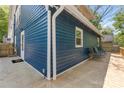 Spacious back deck showcases the blue siding and complements outdoor seating, perfect for entertaining guests at 166 Franklin Nw Ave, Concord, NC 28025