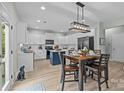 Charming eat-in kitchen with stainless steel appliances and light countertops with navy island at 1809 Robbins Meadows Dr, Waxhaw, NC 28173
