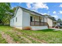 Side view of single-story home with quaint porch and grassy yard at 1901 Parkdale Ave, Gastonia, NC 28052
