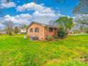 A brick home with a large, well-maintained grassy backyard at 1910 York Hwy, York, SC 29745