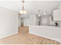 Bright dining space with light wood floors and modern pendant lighting at 219 Edinburgh Ct, Mount Holly, NC 28120