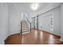 Bright foyer with hardwood floors, staircase, and a front door featuring sidelights and a transom window at 235 Boxelder Rd, Clover, SC 29710