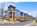 A modern apartment complex with blue and beige exterior and well-maintained landscaping at 2401 Euclid Ave, Charlotte, NC 28203