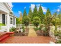 A garden path and white picket fence lead to this home, with lots of lush greenery at 292 Mocksville Hwy, Statesville, NC 28625
