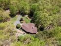 Aerial view of a wood-roofed house nestled in a green forest, showcasing privacy at 3605 Ridgetop Rd, Sherrills Ford, NC 28673
