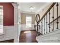 Elegant foyer with hardwood floors, staircase, and decorative mirror creating a welcoming entry at 4013 Highgate Ln # 2B-78, Lancaster, SC 29720