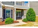 Inviting front porch with stone accents, white railings, and a cozy seating area with rocking chairs at 4013 Highgate Ln # 2B-78, Lancaster, SC 29720