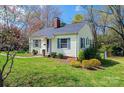 Quaint home with blooming tree in front yard and well-kept lawn at 713 8Th Street Nw Dr, Hickory, NC 28601