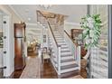 Elegant foyer with a staircase, hardwood floors, and decorative accents creating a warm and inviting entrance at 727 Bluff Loop Rd, Rock Hill, SC 29730