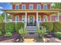 Charming red brick home featuring a welcoming front porch, manicured landscaping, and a well-maintained walkway at 727 Bluff Loop Rd, Rock Hill, SC 29730