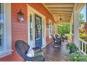 Inviting front porch with wicker seating, seasonal decor, and a ceiling fan for relaxing outdoor enjoyment at 727 Bluff Loop Rd, Rock Hill, SC 29730