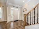 Bright foyer with beautiful door, sidelights, wooden floors, and a staircase to the upper level at 10024 Fox Trotter Ln, Midland, NC 28107