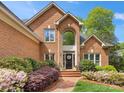 Close-up of a home's entrance featuring a brick walkway, manicured landscaping, and a welcoming front door at 10626 Newberry Park Ln, Charlotte, NC 28277
