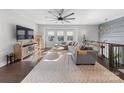 Bright living room features large windows, hardwood floors, and an open layout with a cozy sectional sofa at 11039 Stetler St, Charlotte, NC 28204
