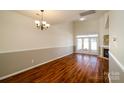Bright living room with hardwood floors, high ceilings, a fireplace, and access to the backyard at 11630 Lioness St, Charlotte, NC 28273