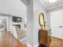 Bright foyer with hardwood floors, gray walls, and decoratively appointed wooden side table at 1310 Woodland Dr, Charlotte, NC 28205